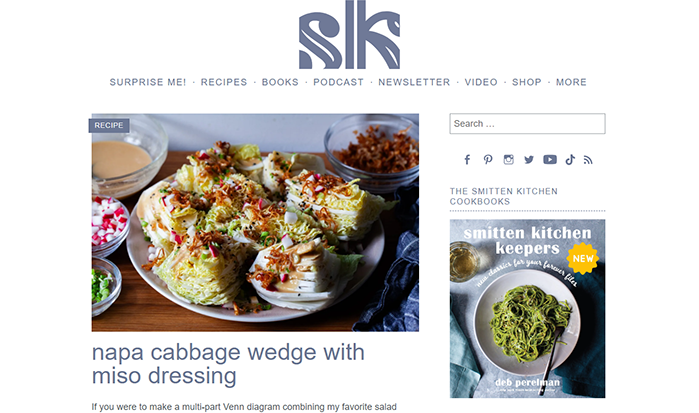 A website page showing a recipe for Napa cabbage wedge with miso dressing. The image features wedges of Napa cabbage topped with miso dressing, garnished with various toppings.