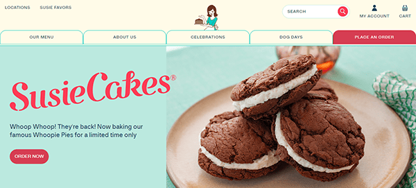 Homepage of SusieCakes' website, featuring double chocolate whoopie pies with cream filling. Header includes menu, about, celebrations, dog days, and place an order tabs. .