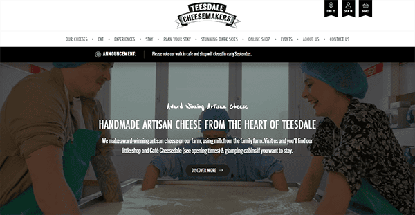 Website homepage of Teesdale Cheesemakers, featuring two people pressing cheese curds. The site advertises handmade artisan cheese and includes navigation links and a shop announcement.