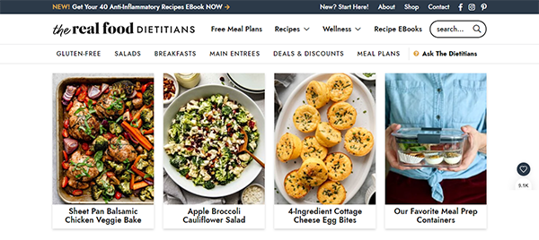 Website homepage of The Real Food Dietitians displaying a row of four food images: Sheet Pan Balsamic Chicken Veggie Bake, Apple Broccoli Cauliflower Salad, 4-Ingredient Cottage Cheese Egg Bites, and meal prep containers.