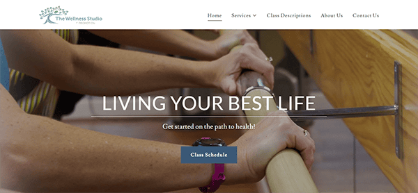 Website homepage for The Wellness Studio, featuring an image of a person using exercise equipment, with the text "LIVING YOUR BEST LIFE" and a "Class Schedule" button. Navigation menu is visible.