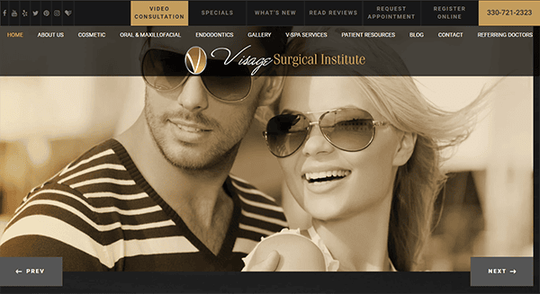 A black and white image of a smiling man and woman wearing sunglasses is displayed on the homepage of the Visage Surgical Institute website. Various menu options are visible at the top of the page.