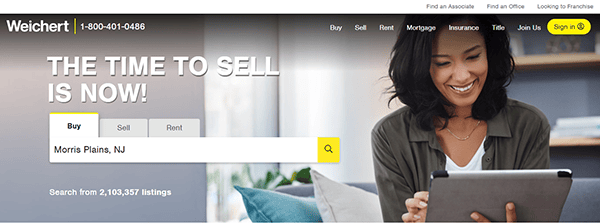 A woman smiling while looking at a tablet on the homepage of Weichert, emphasizing "The time to sell is now!" and including a property search bar for Morris Plains, NJ.