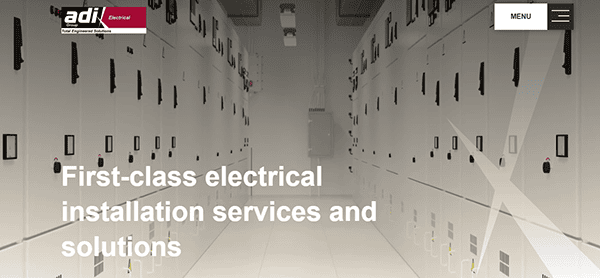 A hallway between rows of electrical control panels with the text "First-class electrical installation services and solutions" and a "MENU" button in the top right corner.