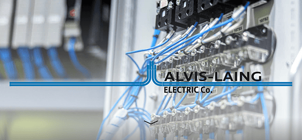 Close-up of electrical equipment with blue and white wires connected to terminals. The text "ALVIS-LAING ELECTRIC CO." is overlaid on the image.