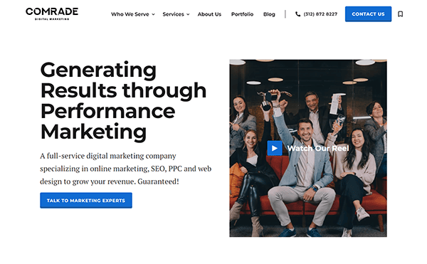 A website homepage for Comrade, a digital marketing company, featuring a header with a group of people holding drinks, contact information, and a button to contact marketing experts.