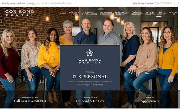 A group photo of eight people, six women and two men, standing and sitting in front of a brick wall at Cox Bond Dental. Text includes contact information and the message: “With us, IT'S PERSONAL.”.