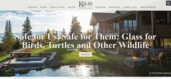 A scenic outdoor setting with a building, a pond, and seating areas, featuring text promoting wildlife-safe glass solutions. The Kolbe Windows & Doors logo is at the top.