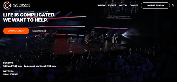 A stage with a band performing at North Point Community Church. The screen displays "Life is complicated. We want to help." Service times and join instructions are listed at the bottom.