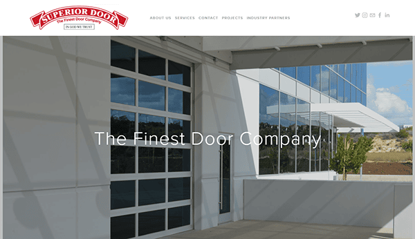 Website homepage of Superior Door Company, featuring a modern building with large windows and the slogan "The Finest Door Company" overlaid in front. Logo and navigation menu at the top highlight why we are your choice for the best garage door solutions.