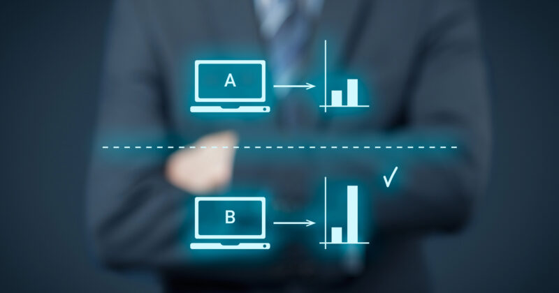 A businessperson stands confidently with arms crossed, showcasing digital graphics of two computer icons labeled A and B. Accompanied by bar graphs and a checkmark next to B, this visual underscores the outcome of split tests, highlighting enhanced campaign performance.