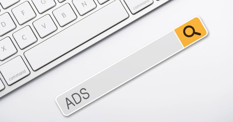 A keyboard featuring a search bar labeled "ADS" with a yellow icon on a white background, designed for crafting effective Google Ads that drive high conversions.