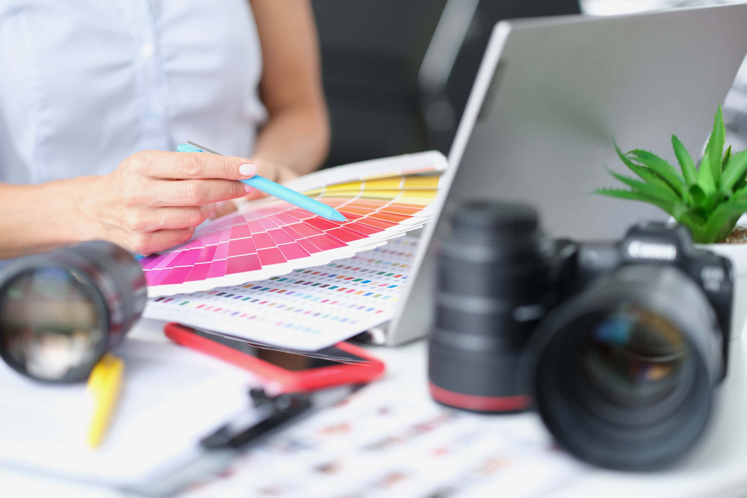 Woman photographer designer selects color shades for photographs