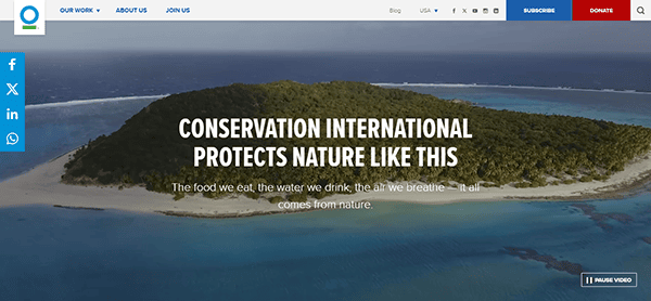 Aerial view of an island with the text: "Conservation International protects nature like this. The food we eat, the water we drink, the air we breathe—it all comes from nature. Discover top charity websites and join efforts to preserve our planet.