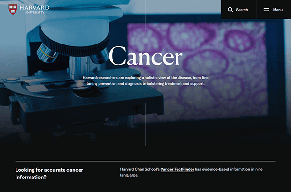 Image of one of the best college websites, featuring a microscope and slide projection, with text about Harvard researchers exploring cancer prevention, diagnosis, and treatment.