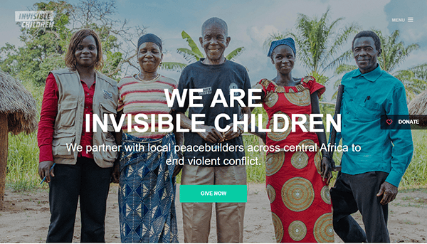 Five people stand together smiling outdoors, with text overlay reading, "We are Invisible Children," and a message about partnering to end conflict in central Africa. Discover more on our charity website and see how you can help make a difference.