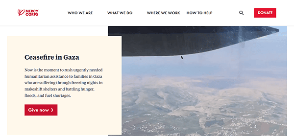 A website screenshot displays a Mercy Corps appeal for humanitarian assistance in Gaza, complete with a donate button and an aerial view of the landscape beneath an aircraft wing. As one of the best charity websites, it offers a seamless way to contribute to vital aid efforts.