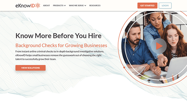 Three people in an office setting concentrate on a task together, highlighting the collaborative spirit of eKnowID. The image enhances the webpage's message, promoting background check websites as essential solutions for businesses.