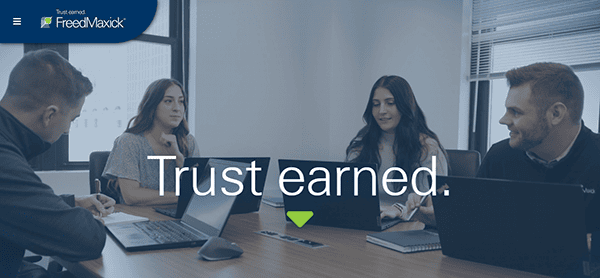 Four people in a meeting room with laptops, under the text "Trust earned" and a logo in the corner—a setting where top accountant websites come to life.