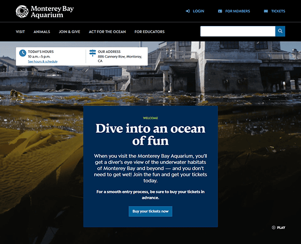 The Monterey Bay Aquarium website homepage elegantly showcases a message about visiting and tickets, all set against a stunning backdrop of kelp and water, making it one of the best aquarium websites for enthusiasts to explore.