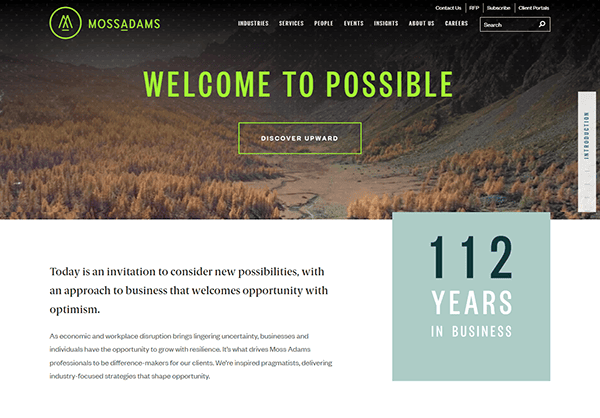 Screenshot of Moss Adams website homepage showcasing the phrase "Welcome to Possible" and "112 Years in Business" against a serene valley backdrop, featuring a button labeled "Discover Upward." Recognized among the best accountant websites for its engaging design.