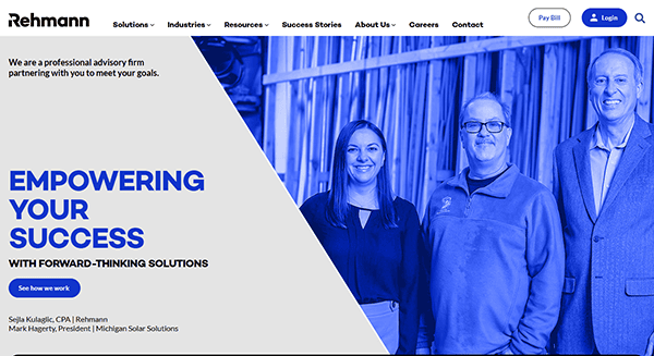 Three people posing in front of a wooden backdrop with a blue tint. Text on the left reads: "Empowering your success with forward-thinking solutions." Experience the best accountant websites to elevate your financial services.