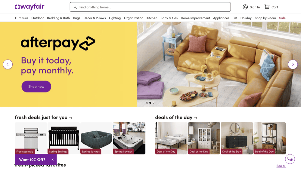 Wayfair's homepage showcases a vibrant yellow banner for Afterpay above a sleek sectional sofa image, spotlighting featured product deals on furniture and home goods below. As one of the best home decor websites by 2025, it offers irresistible shopping experiences.